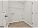 Laundry room with wood-look flooring and wire shelving at 613 Ambrose Ln, Peachtree City, GA 30269