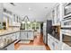 Modern kitchen with white cabinets, granite counters, and stainless steel appliances at 119 Castlewood Rd, Tyrone, GA 30290