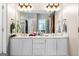 Double vanity bathroom with updated light fixtures at 2800 S Highway 16, Carrollton, GA 30116