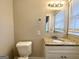 Clean bathroom with granite countertop, single sink vanity, and updated fixtures at 2390 Candler Rd, Decatur, GA 30032
