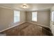 Cozy carpeted bedroom with neutral walls and ample window light at 2390 Candler Rd, Decatur, GA 30032