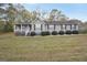 Gray house with a front porch and landscaped yard at 2096 Old Jackson Rd, Locust Grove, GA 30248