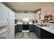 Modern kitchen with white and green cabinets and stainless steel appliances at 2096 Old Jackson Rd, Locust Grove, GA 30248