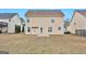 Two-story house back view, featuring a small patio and yard at 5737 Colonnade Dr, Rex, GA 30273