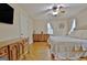 Main bedroom with king-size bed, dresser, and hardwood floors at 435 Crabapple Rd, Fayetteville, GA 30215