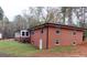 Brick ranch home showcasing a sunroom addition and partial basement exposure at 2193 Hiram Douglasville Hwy, Hiram, GA 30141