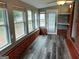 Bright sunroom with brick feature wall and laminate flooring at 2193 Hiram Douglasville Hwy, Hiram, GA 30141