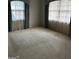 Bedroom with light blue curtains and wall-to-wall carpeting at 4929 Joy Sw Ln, Lilburn, GA 30047