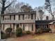 Two-story house with brick and siding exterior, featuring a large yard at 4929 Joy Sw Ln, Lilburn, GA 30047