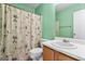 Clean bathroom with a shower/tub combo and wood vanity at 453 Camp Hill Ln, Jonesboro, GA 30238