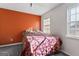 Spacious bedroom with orange accent wall and a comfortable bed at 453 Camp Hill Ln, Jonesboro, GA 30238