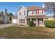 Two-story house with attached garage, red accents, and a yard at 453 Camp Hill Ln, Jonesboro, GA 30238