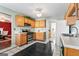 Bright kitchen with wood cabinets and tile floor at 453 Camp Hill Ln, Jonesboro, GA 30238