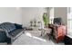 Living room with leather sofa, wooden desk, and large windows at 453 Camp Hill Ln, Jonesboro, GA 30238