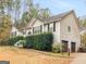 Side view of a ranch home with a two-car garage and landscaping at 228 Grove Pointe Dr, Locust Grove, GA 30248