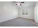 Bright bedroom with ceiling fan and carpet at 7030 Setters Way, Lithonia, GA 30038