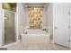 Bathroom with a garden tub and shower at 745 Woodscape Trl, Johns Creek, GA 30022