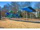 Community playground with slides, climbing structures, and shade at 745 Woodscape Trl, Johns Creek, GA 30022