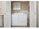 Bright laundry room with washer, dryer, and cabinets at 707 Dunbar Dr, Dunwoody, GA 30338