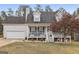 Two-story house with a front porch and attached garage at 1144 Pickets Ridge Dr, Locust Grove, GA 30248