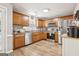 Modern kitchen with wooden cabinets, stainless steel appliances, and L-shaped layout at 1144 Pickets Ridge Dr, Locust Grove, GA 30248