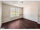 Simple bedroom with wood flooring and a window at 800 Meadowbrook Dr, Mcdonough, GA 30253