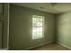 Simple bedroom with a window and neutral-colored walls at 221 Lakeview Dr, Stockbridge, GA 30281
