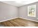 Bright bedroom with neutral walls and wood-look flooring at 1010 Butterfly Cove Way, Locust Grove, GA 30248