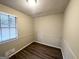Cozy bedroom with neutral walls and hardwood floors at 4395 Stonewall Tell Rd, College Park, GA 30349