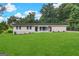 Ranch style home with brick facade, and spacious lawn at 4395 Stonewall Tell Rd, College Park, GA 30349