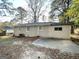Private backyard with a spacious patio and mature trees at 2442 Graywall St, East Point, GA 30344