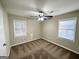 Well-lit bedroom with neutral carpeting and two windows at 2442 Graywall St, East Point, GA 30344
