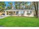 Charming ranch home with a spacious lawn and covered carport at 2442 Graywall St, East Point, GA 30344