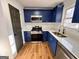 Modern kitchen with stainless steel appliances and blue cabinets at 473 Amy Blvd, Temple, GA 30179