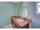 Bathroom with single vanity, mirror, and tiled flooring at 1109 Mcdonald Rd, Covington, GA 30014