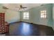 Living room with a brick fireplace, ceiling fan, and dark wood-look flooring at 1109 Mcdonald Rd, Covington, GA 30014