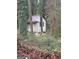 Small white guest house nestled in a wooded area at 5623 Westhill Cir, Atlanta, GA 30349