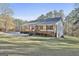 White farmhouse with a wrap-around porch and grassy yard at 1234 Coweta Heard Rd, Hogansville, GA 30230