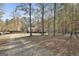 Ranch home with a long driveway and wooded area at 1234 Coweta Heard Rd, Hogansville, GA 30230