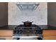 Gas cooktop with modern range hood and dark countertops at 4840 Moon Rd, Powder Springs, GA 30127