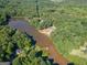 Aerial view of lakefront property with houses and lush green surroundings at 313 Dingler Rd, Moreland, GA 30259