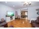 Bright living room with hardwood floors, comfy seating, and large TV at 313 Dingler Rd, Moreland, GA 30259