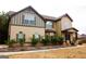 Two-story house with beige siding, brown accents, and landscaping at 80 Tanners Ct, Covington, GA 30016