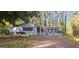 Ranch style home with brick and siding exterior, white picket fence, and driveway at 3603 Manhattan Dr, Decatur, GA 30034