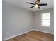 Well-lit bedroom, ceiling fan, hardwood floors, and a window with blinds at 5359 Megan Rd, Stone Mountain, GA 30088