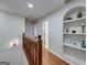 Upstairs hallway with built-in shelving and hardwood floors at 442 Summit Ridge Dr, Lawrenceville, GA 30046