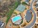 Aerial view of community pool, tennis courts, and parking at 5760 Winding Lakes Dr, Cumming, GA 30028