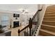 Living room with fireplace, hardwood floors, and view of kitchen at 5760 Winding Lakes Dr, Cumming, GA 30028