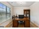 Home office with built-in bookcase and hardwood floors at 5760 Winding Lakes Dr, Cumming, GA 30028