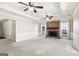 Living room with brick fireplace and ceiling fans at 220 Jeff Davis Pl, Fayetteville, GA 30214